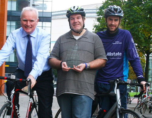 Northern Ireland encourages their employees to cycle to work. Picture are three employees next to their bikes wearing bicycle helmets.