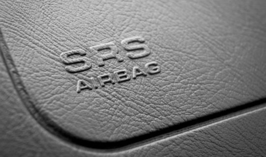 A close-up view of a car dashboard that has an airbag within.