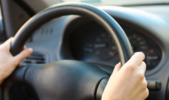 Hands on a steering wheel