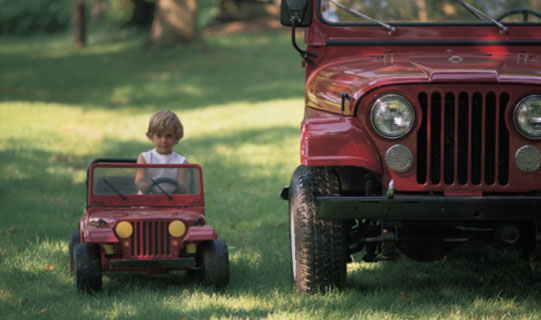 Young boy rides in his mini truck