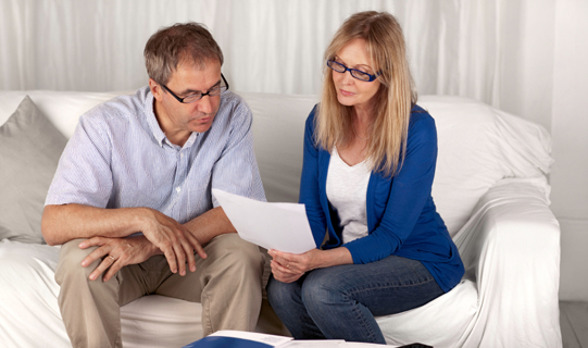 Couple reading insurance information