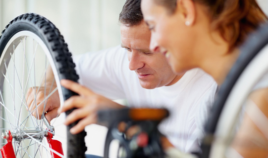 Husband works on his wife's bicycle
