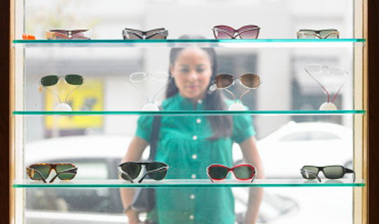 Woman shopping for sunglasses