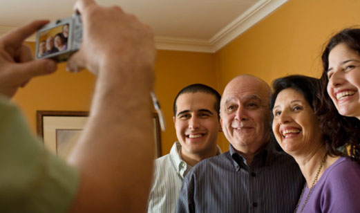 A man takes a picture of his family.