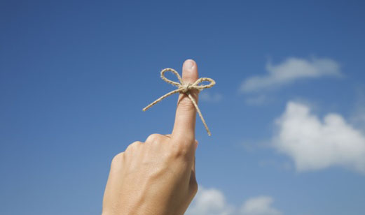 A finger with a string tied around it to act as a reminder.