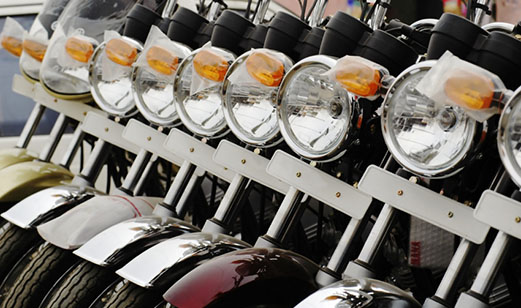 A close-up view of several motorcycles parked in a row.