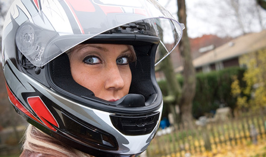 A woman wearing a motorcycle helmet.