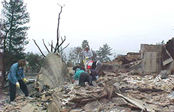 People cleaning up after storm. 