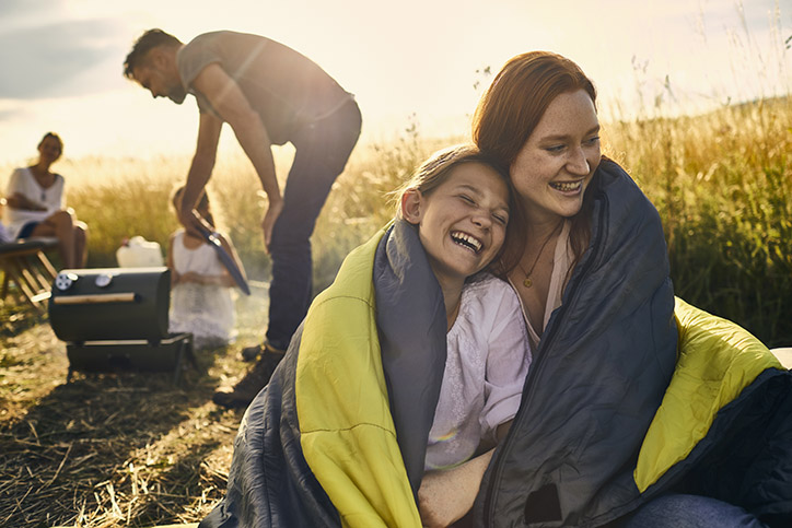 A family outside enjoying a barbecue.