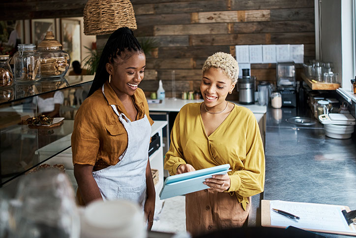 Young women managing a coffee shop.