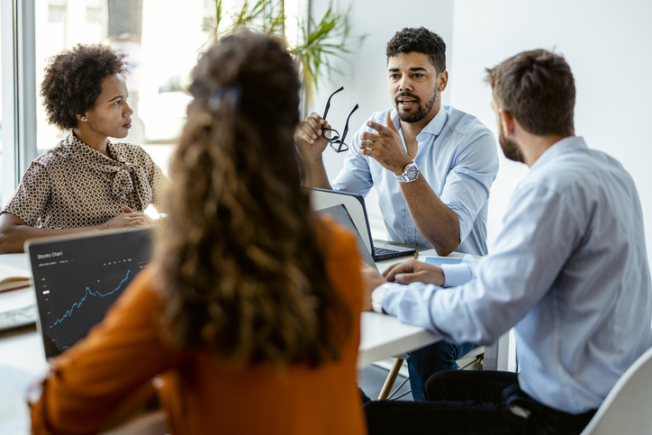 People having a meeting around a table.