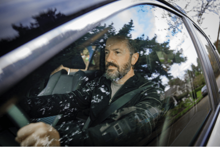 Man driving car.