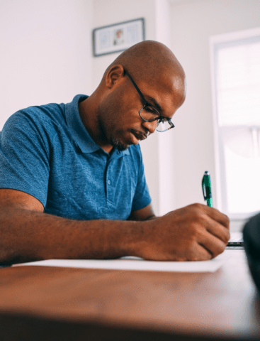 Man writing in notebook. 