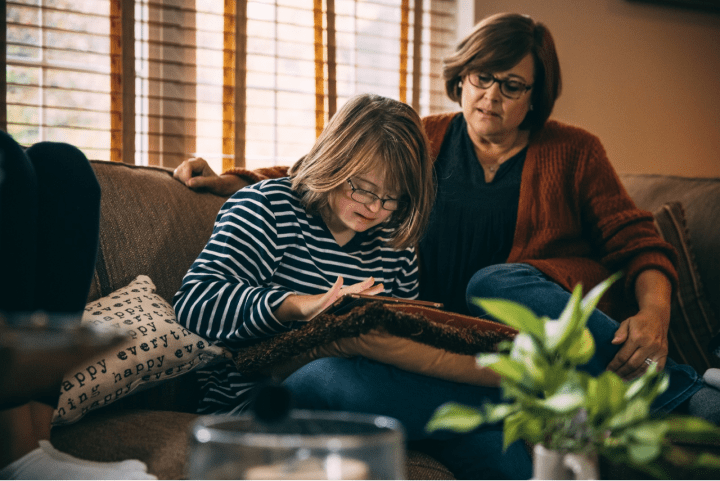 Woman and daughter on couch.