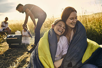 A family outside enjoying a barbecue.