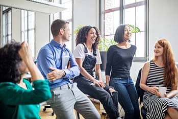 Group of coworkers talking and laughing.