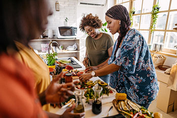 Women in a kitchen preparing a healthy meal