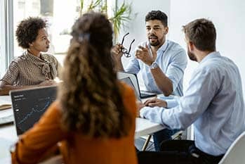 People having a meeting around a table. 