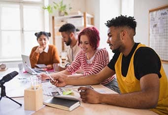 Young co-workers collaborating at a table.