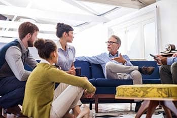 Small group of people listening to another person.