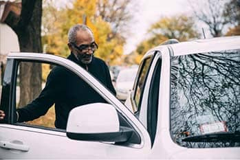 Man getting in car.