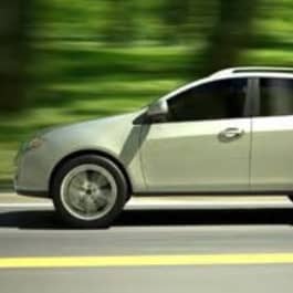 Car driving with blurred background of green background.
