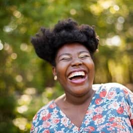 Happy woman laughing outside.