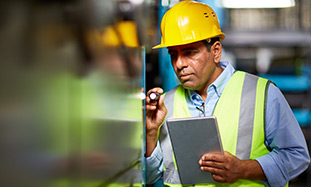 construction worker checking equipment. 