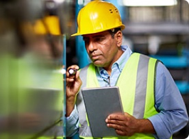 Construction worker checking equipment. 