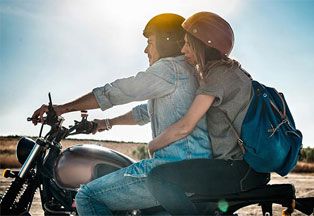 Couple riding together on a motorcycle. 