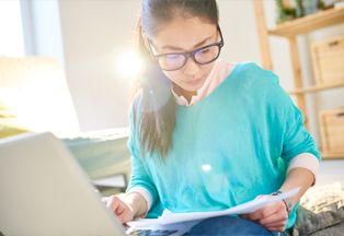 Woman looking at a tax form. 