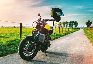 Motorcycle parked on country road. 
