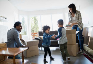 Woman lying on couch looking at laptop. 