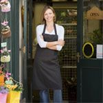 Florist standing in front of her shop. 