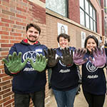 Employees with work gloves on with their hands out.  