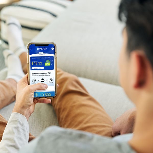 Man looks at Drivewise<sup>&reg;</sup> on his phone. 