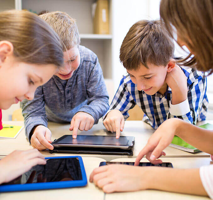 A group of kids using tablets. 