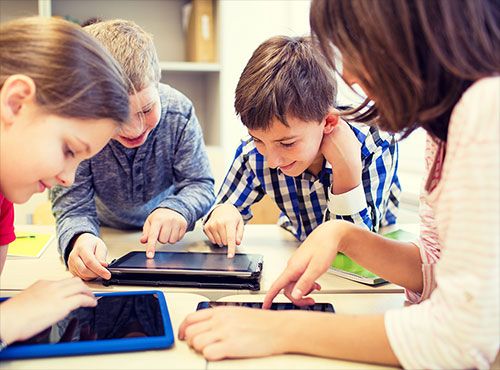 Kids using tablets. 