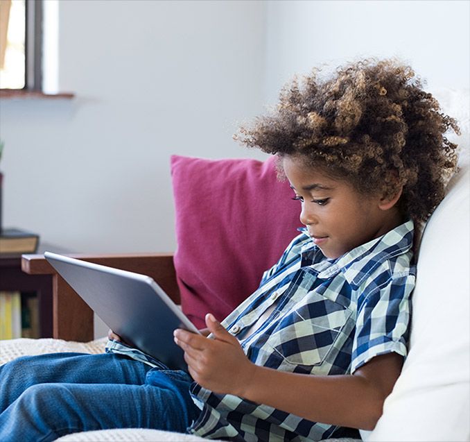 Young boy using a tablet computer. 