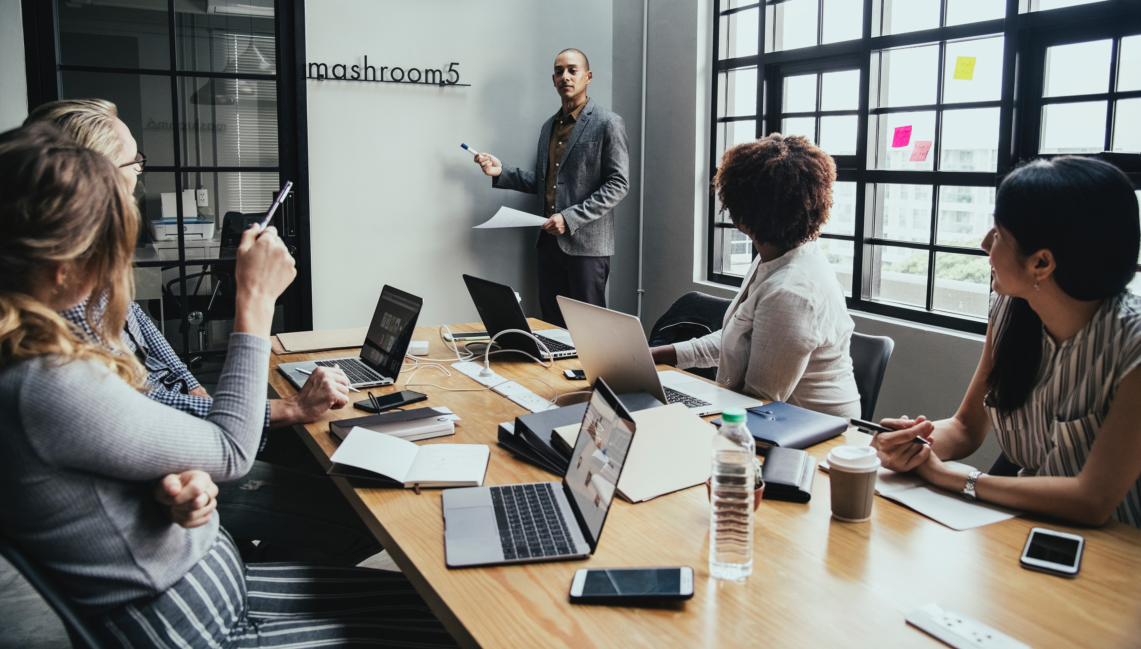 Group of indviduals in a office conference room. 