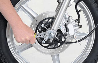 Man fixing his motorcycle wheels