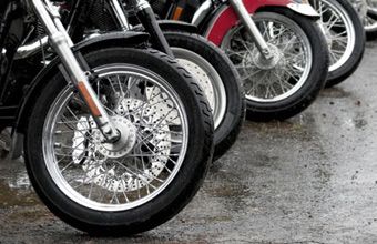 Several motorcycles parked next to one another.