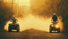 A couple of guys enjoying riding their ATV's. 