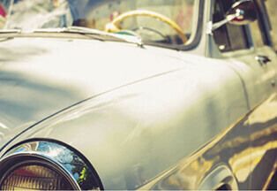 Close up of a vintage-looking car. 