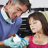 Dentist showing how to brush. 