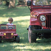 Kid driving toy jeep next to real jeep. Car Insurance Review plans with Chula Vista Allstate Agent Life Insurance with trusted California Licensed Insurance Agency Owner and Advisor Jason Raya in Chula Vista San Diego California. Couple discussing Life Insurance Review plans with Chula Vista Allstate Agent Life Insurance with trusted California Licensed Insurance Agency Owner and Advisor Jason Raya in Chula Vista San Diego California.