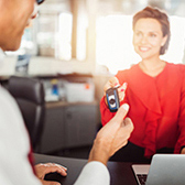 Woman giving keys to man at rental car counter. Car Insurance Review plans with Chula Vista Allstate Agent Life Insurance with trusted California Licensed Insurance Agency Owner and Advisor Jason Raya in Chula Vista San Diego California. Couple discussing Life Insurance Review plans with Chula Vista Allstate Agent Life Insurance with trusted California Licensed Insurance Agency Owner and Advisor Jason Raya in Chula Vista San Diego California.