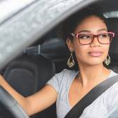 woman and man looking at damage to car after an accident. 