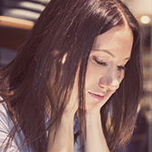 Serious woman looking down. 