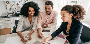 showing couple homeowners insurance information on laptop. 